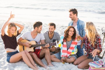 Friends drinking beer at the beach