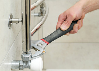 Plumber  sets  valve for towel warmer.