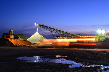 Sand mining night shift with sunset sky