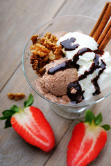 Ice cream sundae, walnuts and sliced strawberry