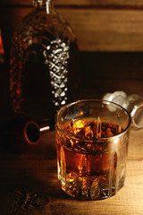 Glass of whiskey and tobacco pipe
