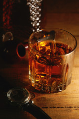 Glass of whiskey, watches and tobacco pipe