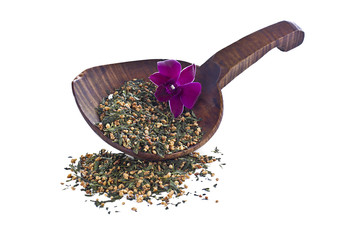 tea leaves and flower with wooden shovel