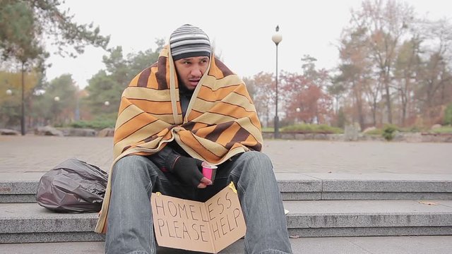 Poor man asking for charity in city park, miserable homeless person needs help