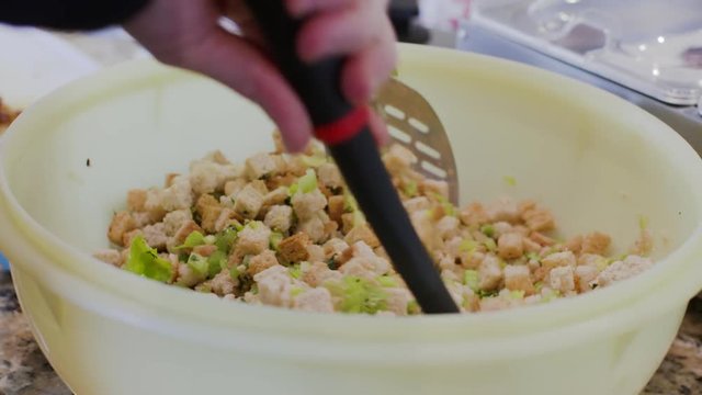 Tossing a Caeser Salad with Lettuce and Cruton