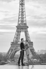 Fototapeta na wymiar Young romantic couple near the Eiffel tower in Paris
