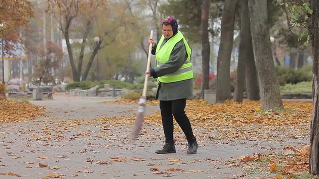 Tired woman working hard as street cleaner, low paid manual labor, poverty