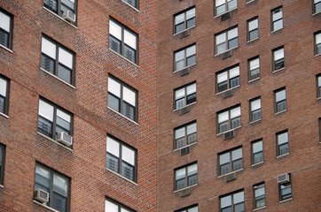 Fototapeta na wymiar Looking up at a detail view of a nyc apartment buildings intersecting perspective