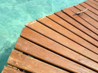 Close up of a wooden pier and Caribbean water