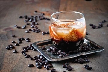 Foto op Canvas Kahlua liqueur with cream in glasses with coffee beans on a wooden background, selective focus © malinkaphoto