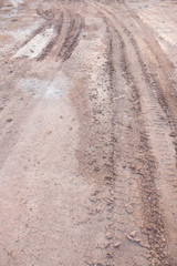 deep ruts of automobile wheels in loamy soil of country road