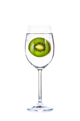 Slices of kiwi fruit and bubble in glass on white background
