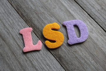 LSD (Lysergic Acid Diethylamide) acronym on wooden background