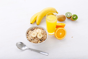 bowl of rolled oats with fruit and juice