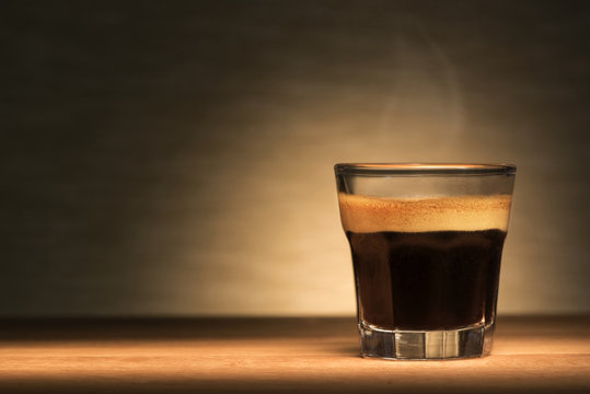 Fototapeta Espresso coffee on a wooden table
