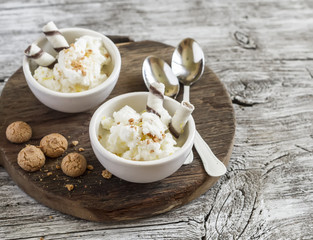 Homemade vanilla ice cream with cookies on rustic light wood background. Delicious summer dessert