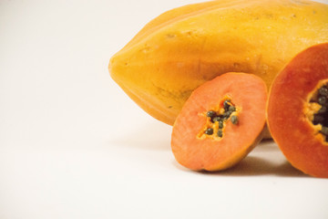 Fresh papaya slice with papaya on dish isolated.Upper right corner1