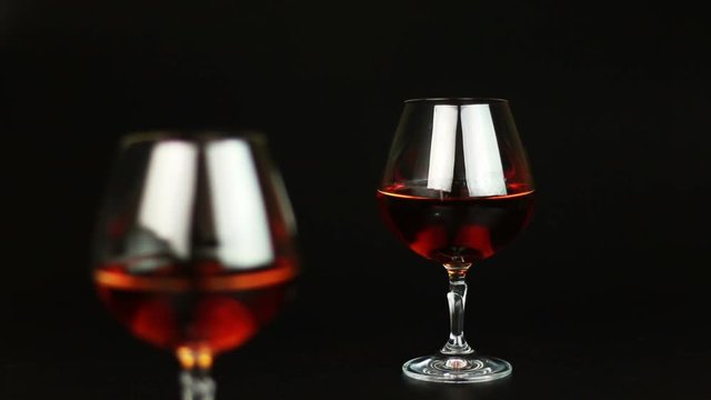 Glass of brandy over black background