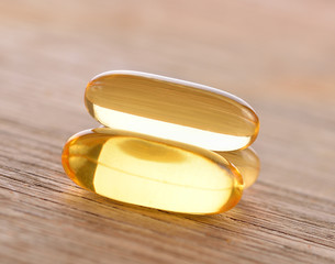 Fish oil capsules  on wooden  background