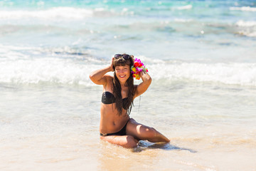 Young sexy woman relaxing on a beach near blue sunny sea. Eternal summer concept.