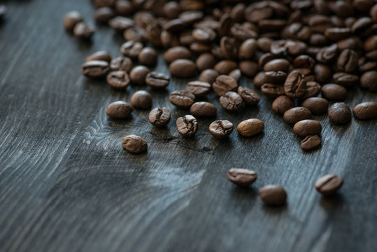 Roasted coffee beans on old wooden table