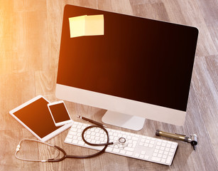 Wood doctor's desk in high definition with laptop, tablet and mo