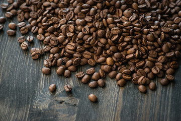 Roasted coffee beans on old wooden table
