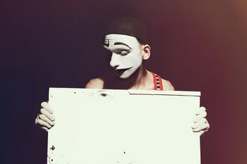 Mime holding white dirty sheet in hands