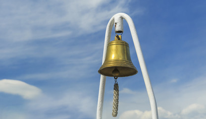 The ship's bell on a background of blue sky