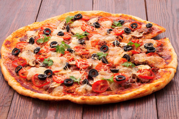Pizza with ham, pepper and olives