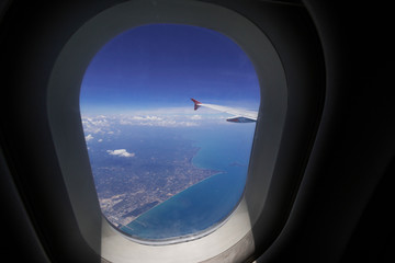 Fototapeta na wymiar Looking through window aircraft during flight in wing with top view 