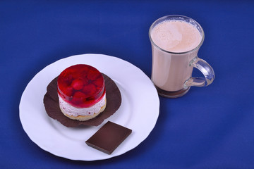 raspberries pastry with cocoa at blue background