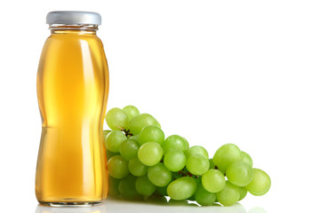 glass bottle of juice and grapes on white isolated background