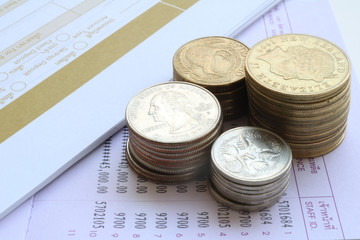 book bank and coins on white background