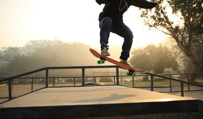 skateboarding woman practice ollie at skatepark