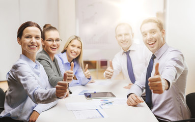 business team showing thumbs up in office