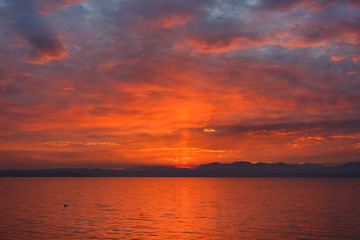 Naklejka na ściany i meble Sunset over the Garda lake