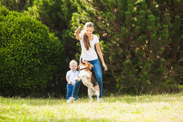 Girl plays with a dog in the yard