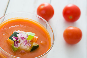 Gazpacho soup on white wooden table

