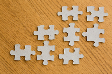 close up of puzzle pieces on wooden surface