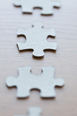 close up of puzzle pieces on wooden surface