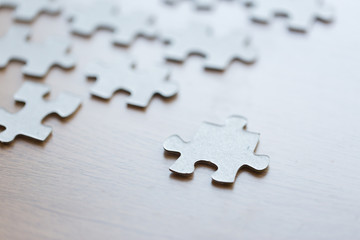 close up of puzzle pieces on wooden surface