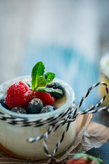 Fresh and healthy natural yogurt with berries on wooden table