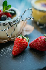 Fresh and healthy natural yogurt with berries on wooden table