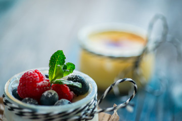 Fresh and healthy natural yogurt with berries on wooden table