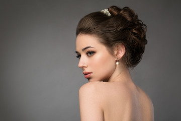 Beautiful sensual brunnete with elegant hairstyle. Wedding acces