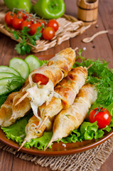 Kebab with tomatoes and cheese in pastry