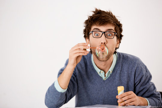 Wild Fun Man Blowing Soap Bubbles At The Table