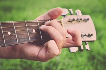 Man and guitar. Man's hand playing the guitar. Guitar Strings (vintage)
