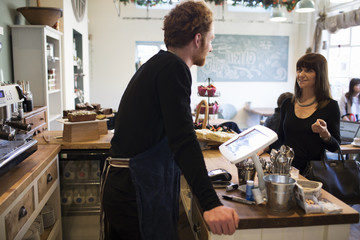  Female Customer Paying In Coffee Shop	
